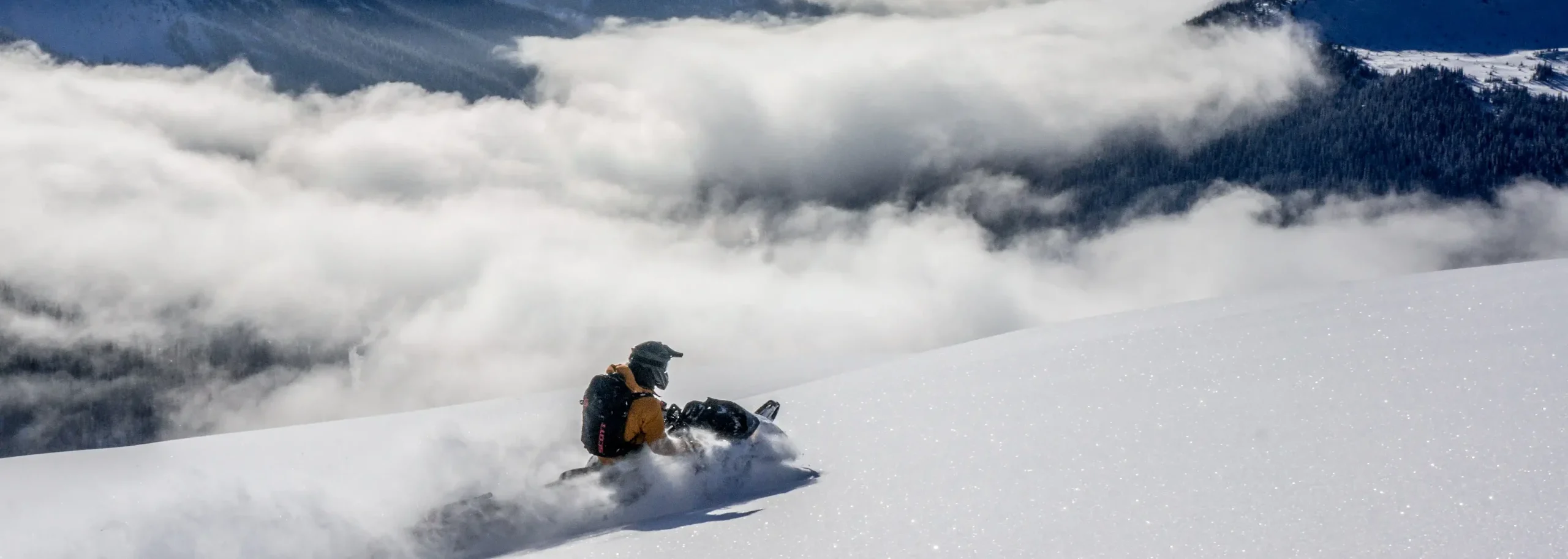 A person snowmobiling on Mount Renshaw