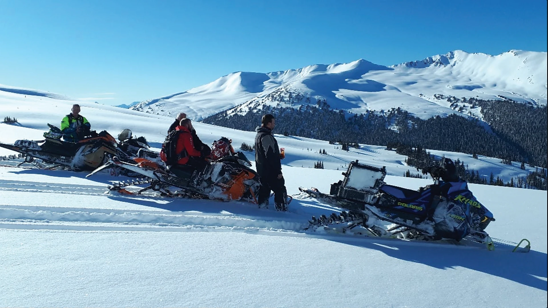 People on snowmobiles on Mount Renshaw