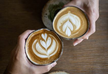 An overhead view of two coffees