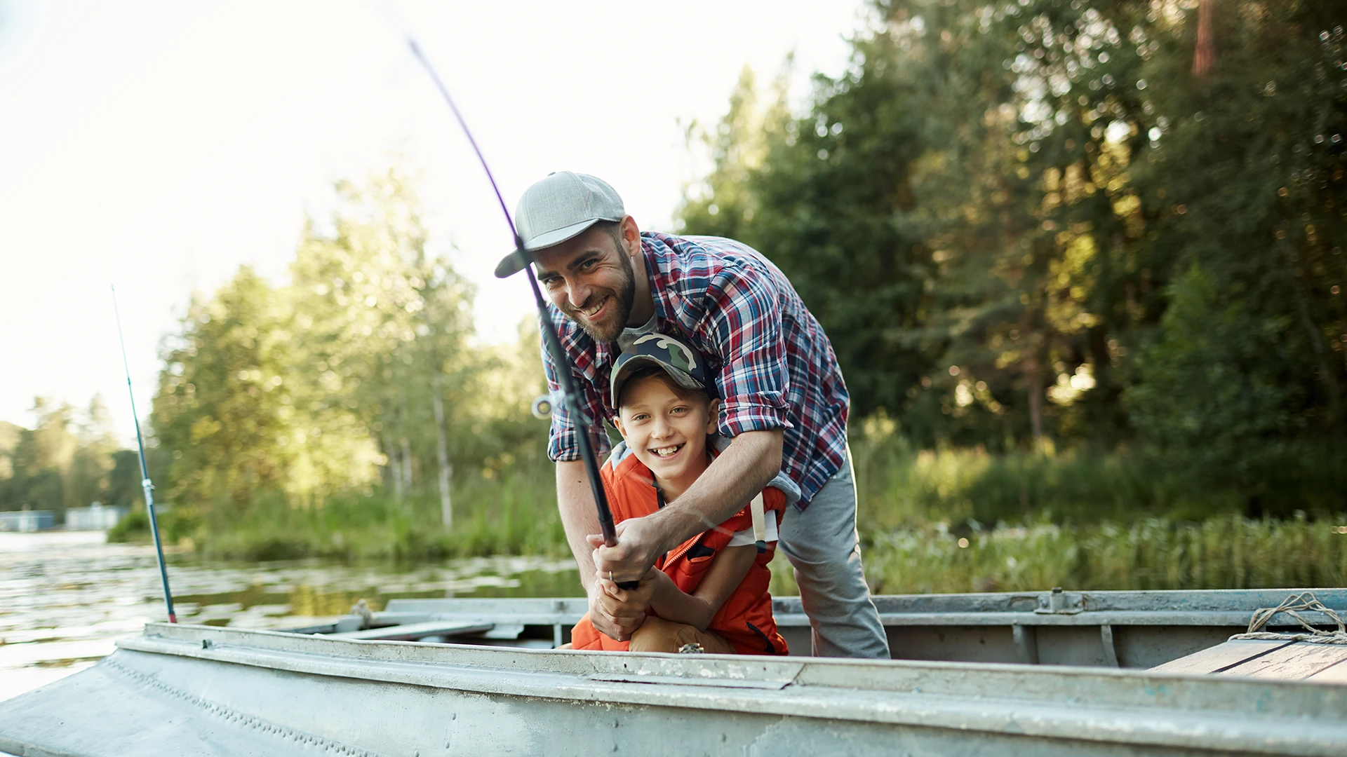 A kid and an adult fishing on a boat