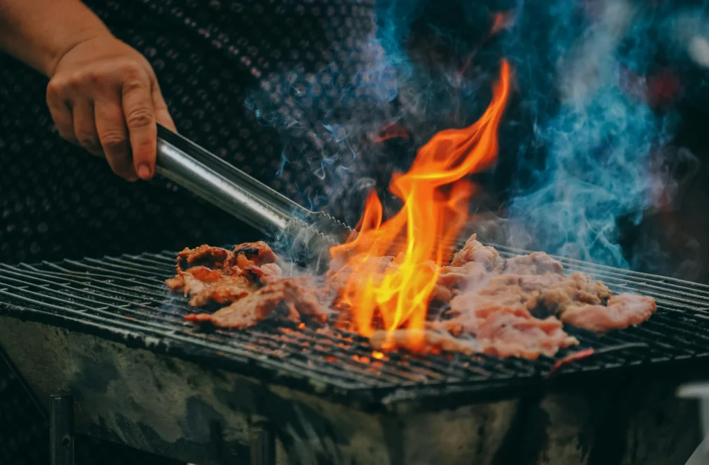 Food on the grill with flames